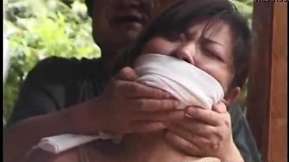 Tied up mature asian cougar to a house beam